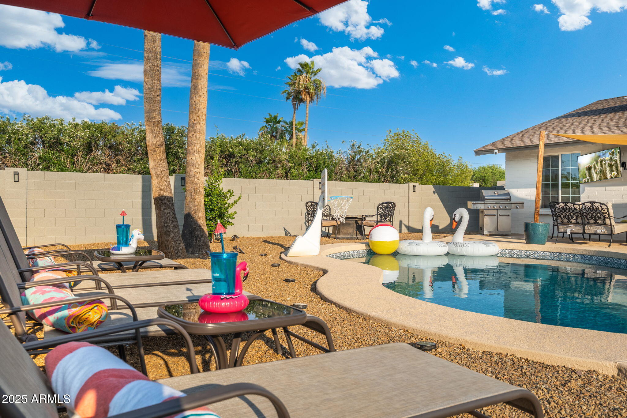 5142 East Nisbet Road Scottsdale, AZ 85254 - Photo 43 of 54 a view of a patio with swimming pool table and chairs