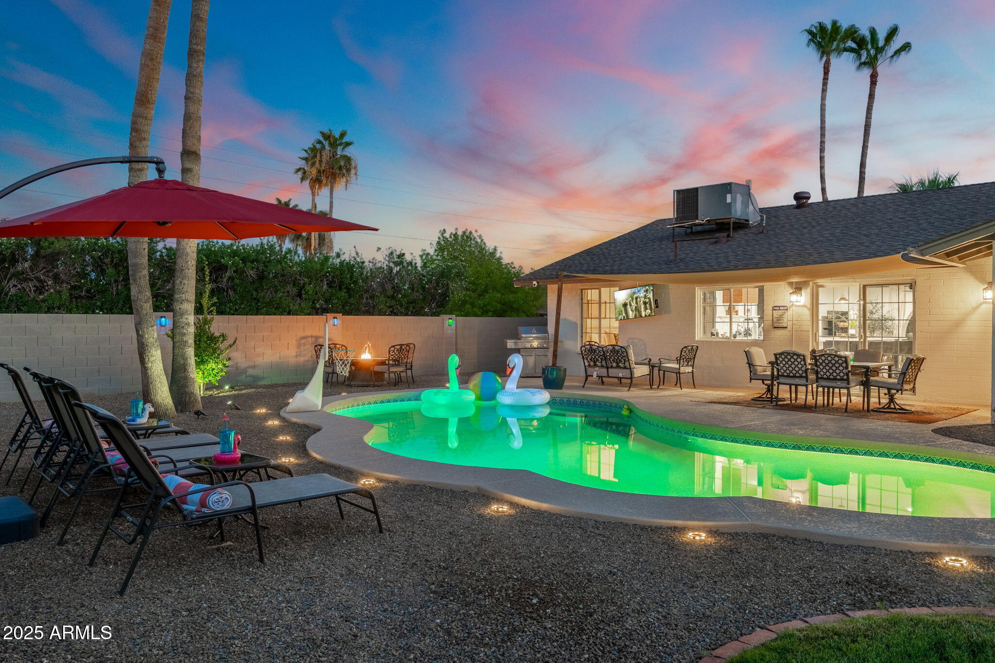 5142 East Nisbet Road Scottsdale, AZ 85254 - Photo 50 of 54 a backyard of a house with table and chairs