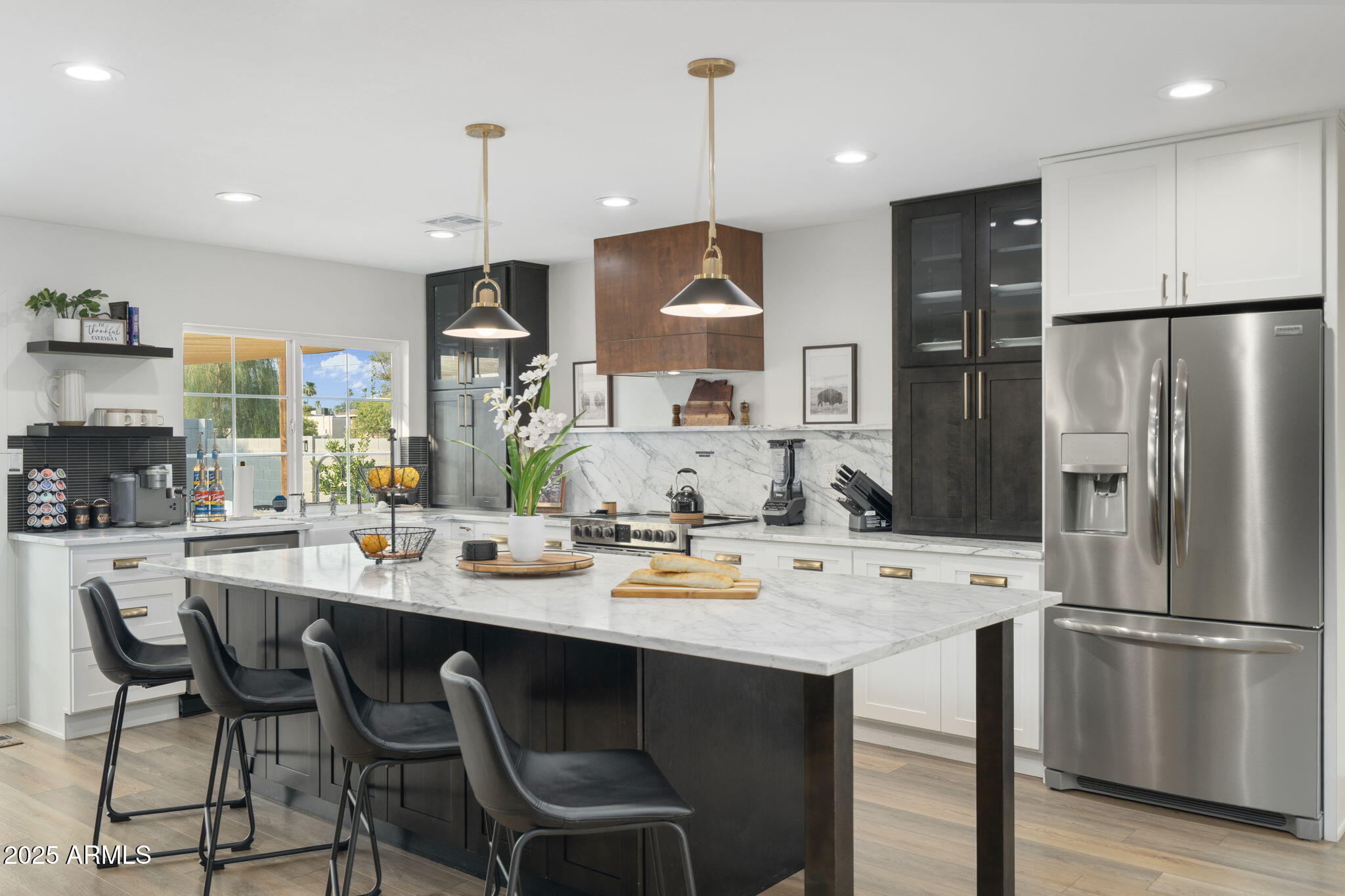 5142 East Nisbet Road Scottsdale, AZ 85254 - Photo 7 of 54 a kitchen with refrigerator a sink and chairs