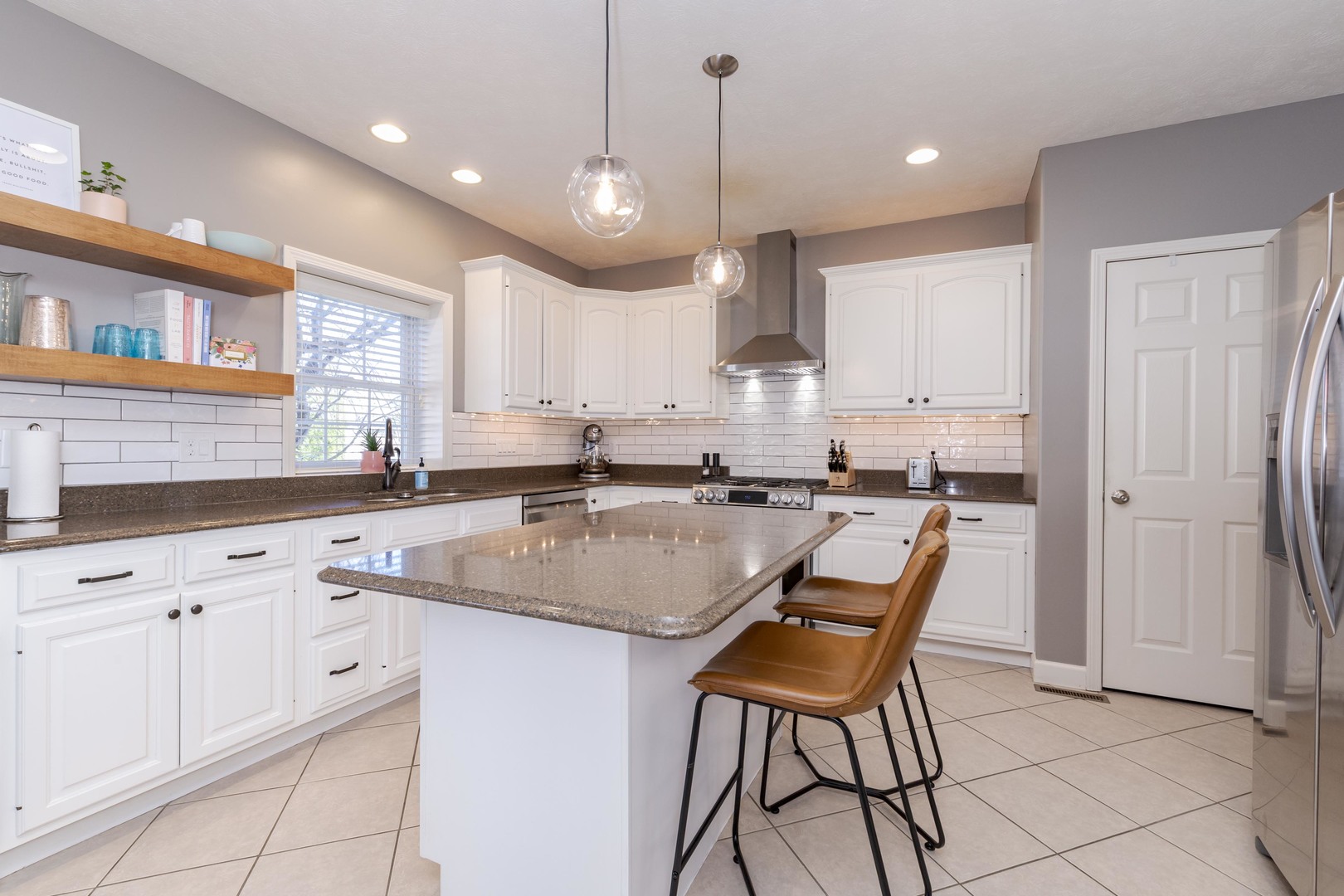 1223 Joy Walk Way Normal, IL 61761 - Photo 4 of 48 a kitchen with stainless steel appliances granite countertop a sink a stove a dining table and chairs