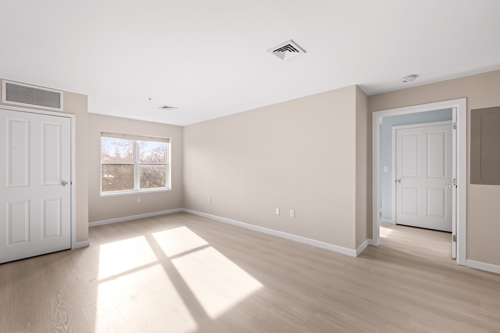30 Franklin Street, Unit 314 Malden, MA 02148 - Photo 11 of 28 a view of empty room with wooden floor and fan