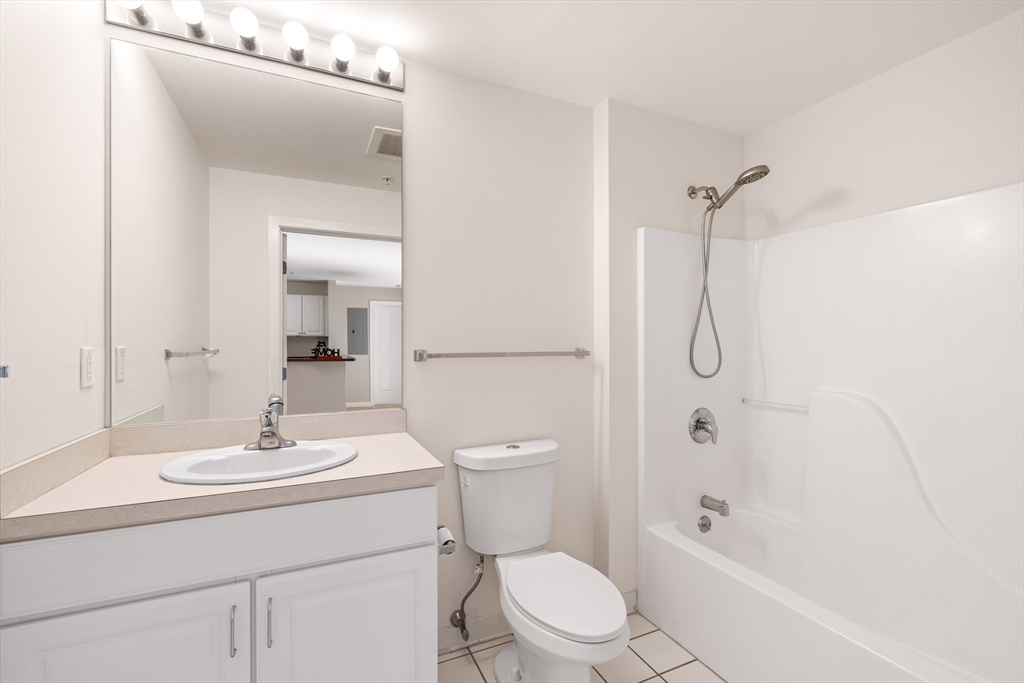 30 Franklin Street, Unit 314 Malden, MA 02148 - Photo 22 of 28 a bathroom with a sink a toilet and shower