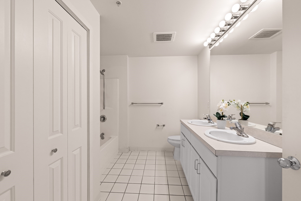 30 Franklin Street, Unit 314 Malden, MA 02148 - Photo 23 of 28 a bathroom with a sink a toilet and shower