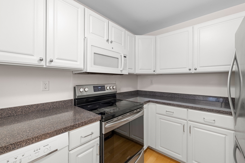 30 Franklin Street, Unit 314 Malden, MA 02148 - Photo 5 of 28 a kitchen with granite countertop white cabinets and a stove