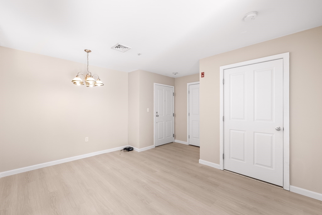 30 Franklin Street, Unit 314 Malden, MA 02148 - Photo 9 of 28 wooden floor in an empty room
