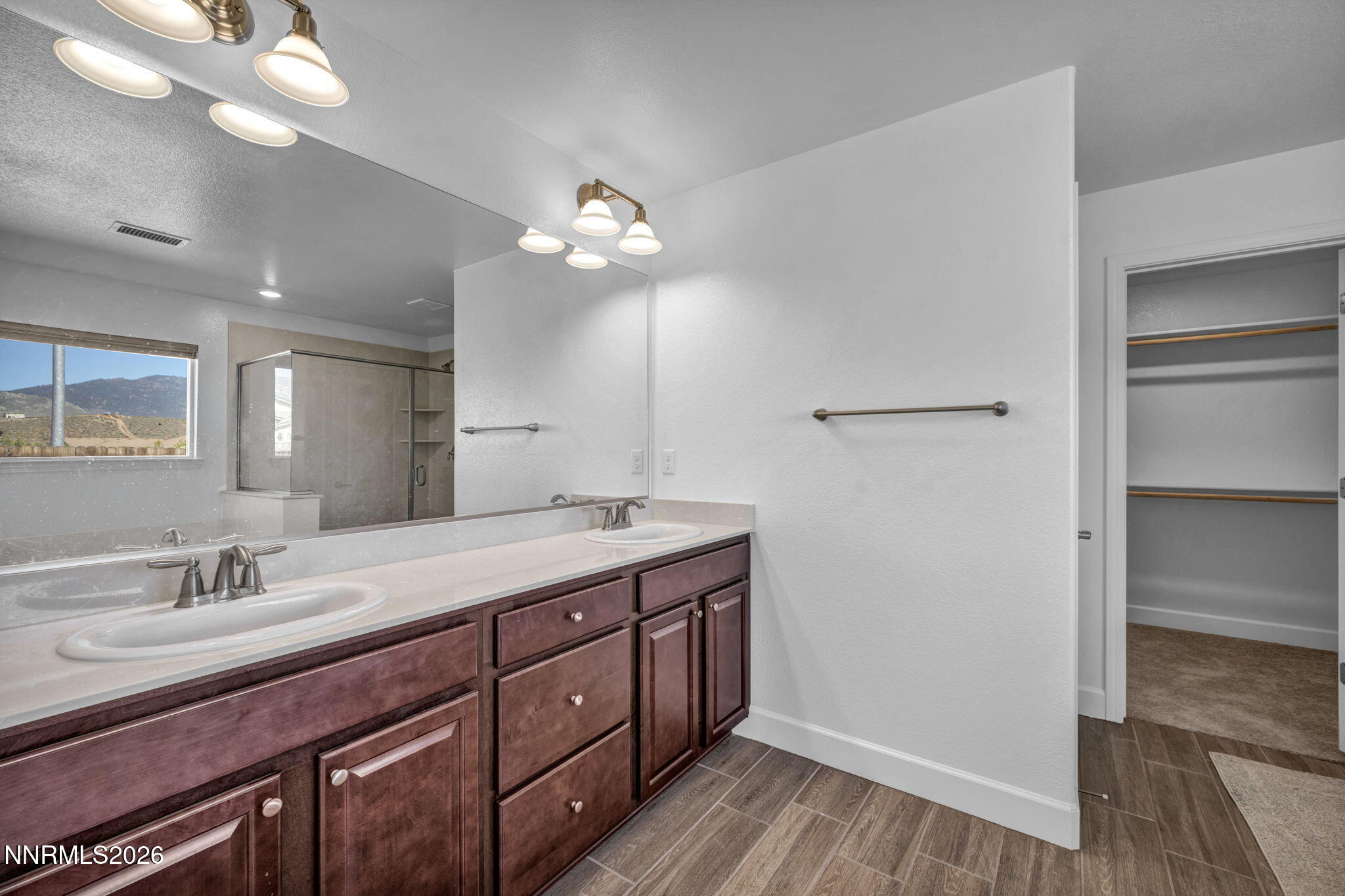 7181 Saddlehorn Road Carson City, NV 89701 - Photo 37 of 62 a spacious bathroom with a granite countertop sink a light fixture and a mirror