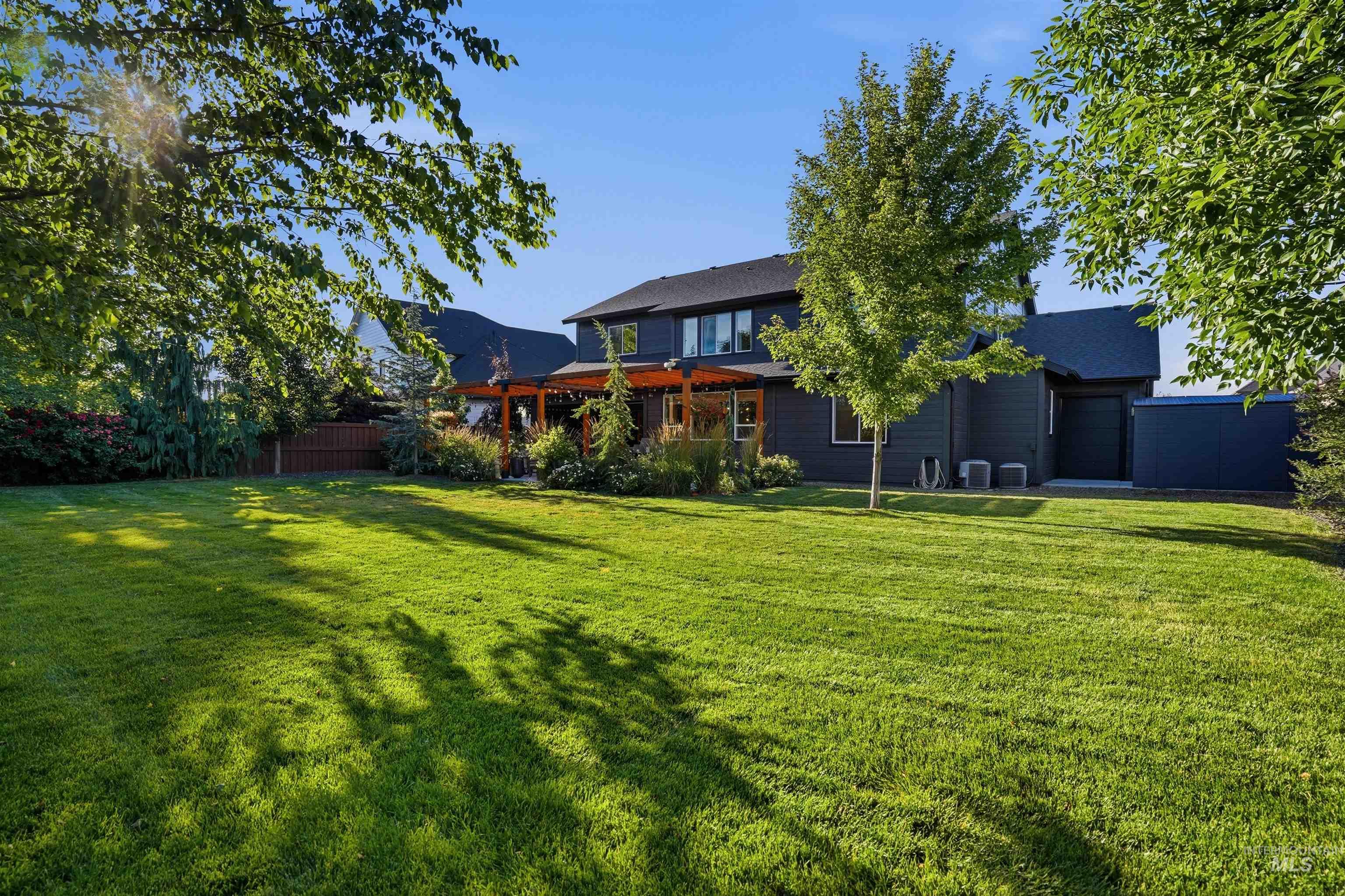 4323 West Ladle Rpds Drive Meridian, ID 83646 - Photo 46 of 49 Expansive green lawn with mature trees and a dark-toned residence