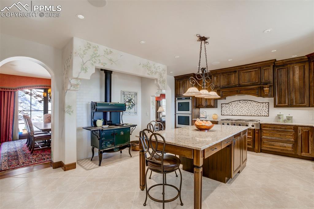 14250 Aiken Ride View Colorado Springs, CO 80926 - Photo 16 of 50 a kitchen that has a table and chairs in it