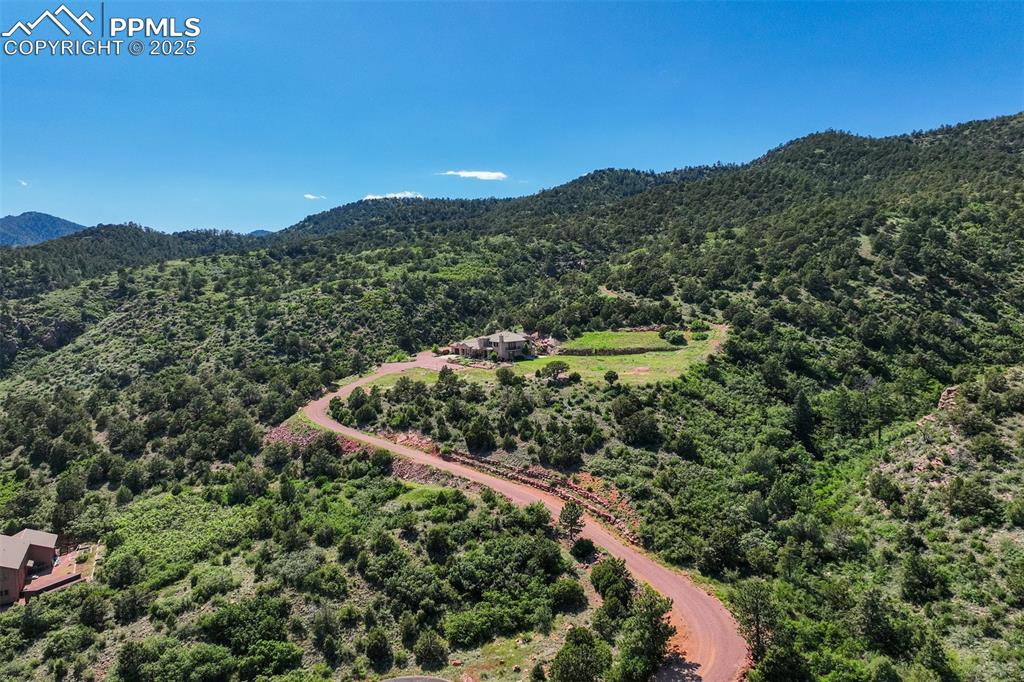 14250 Aiken Ride View Colorado Springs, CO 80926 - Photo 2 of 50 a view of a lush green field with mountains in the background
