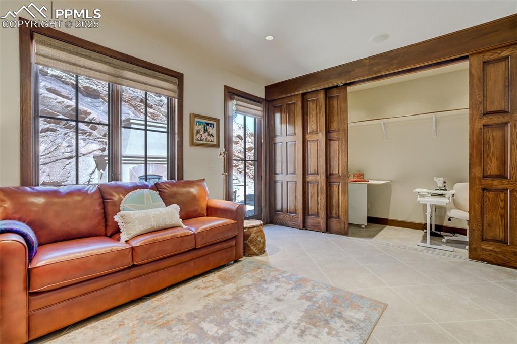 14250 Aiken Ride View Colorado Springs, CO 80926 - Photo 26 of 50 a bedroom with furniture and a large window