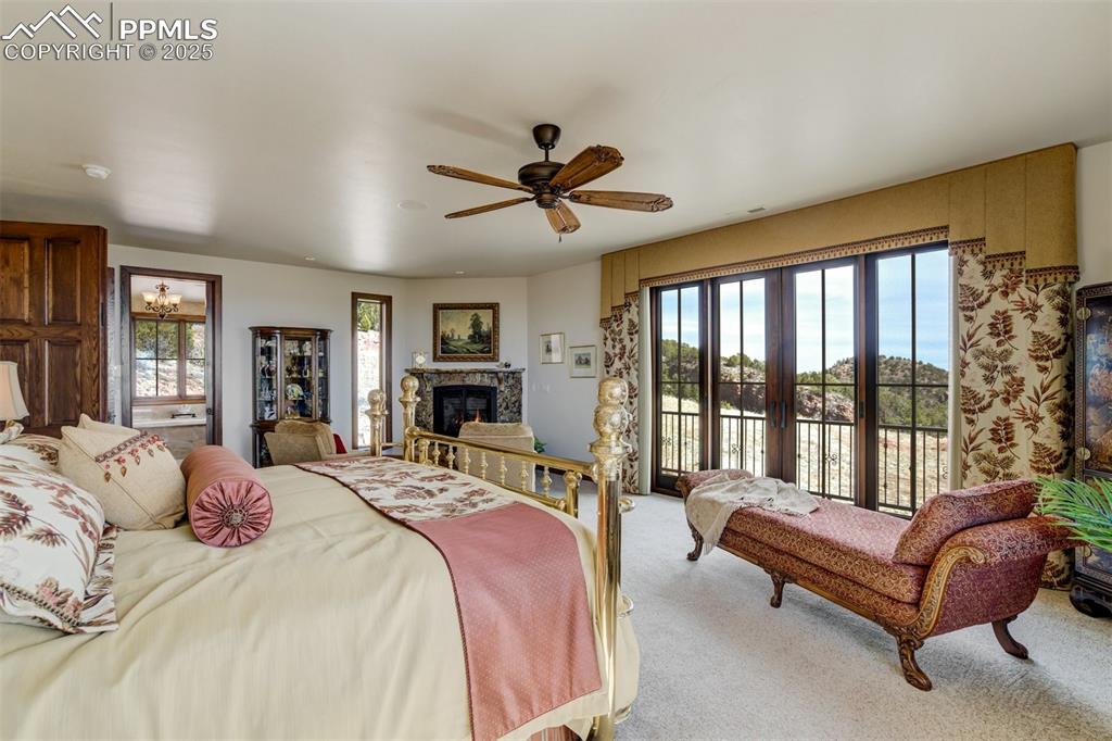 14250 Aiken Ride View Colorado Springs, CO 80926 - Photo 34 of 50 a spacious bedroom with a bed and a large window