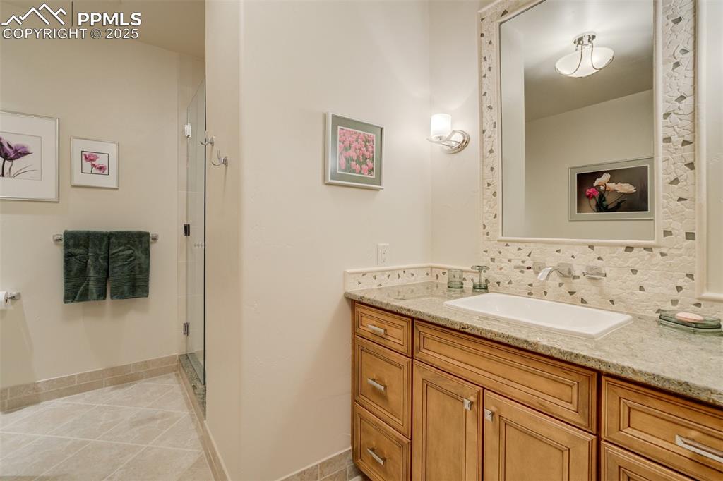 14250 Aiken Ride View Colorado Springs, CO 80926 - Photo 40 of 50 a bathroom with a sink and a mirror