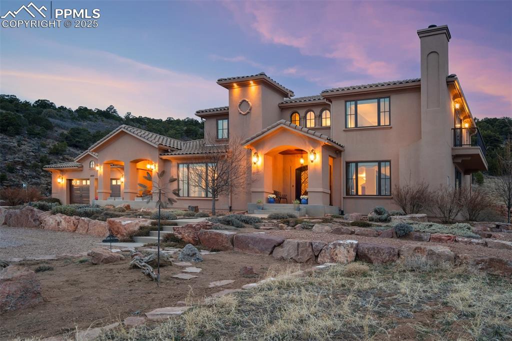 14250 Aiken Ride View Colorado Springs, CO 80926 - Photo 4 of 50 a view of a house with a patio and a yard