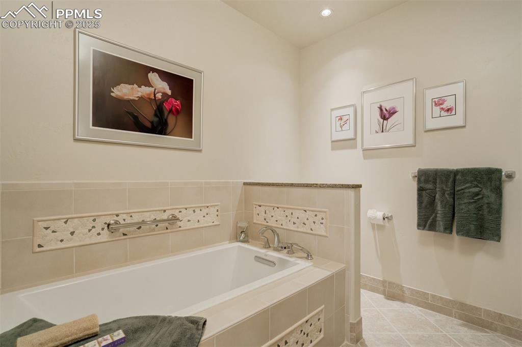 14250 Aiken Ride View Colorado Springs, CO 80926 - Photo 41 of 50 a bathroom with a bathtub and a sink