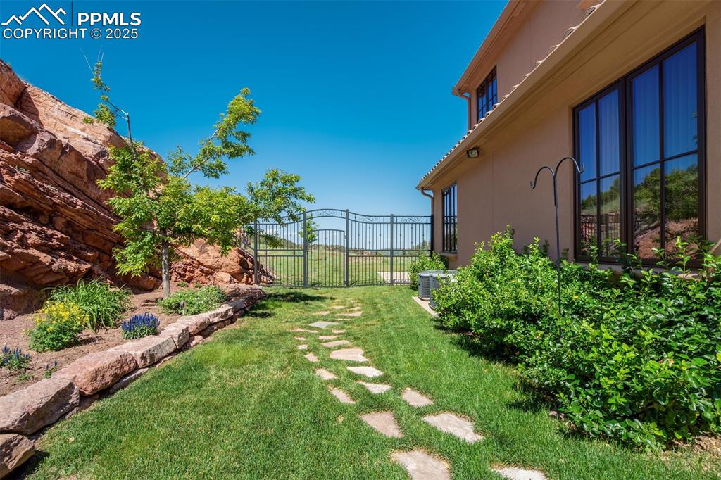 14250 Aiken Ride View Colorado Springs, CO 80926 - Photo 44 of 50 a backyard of a house with lots of green space