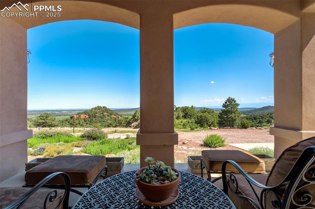 14250 Aiken Ride View Colorado Springs, CO 80926 - Photo 46 of 50 a view of balcony with two chairs and a potted plant