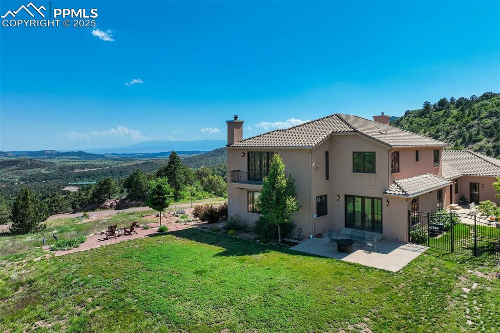 14250 Aiken Ride View Colorado Springs, CO 80926 - Photo 47 of 50 a view of a house with a yard