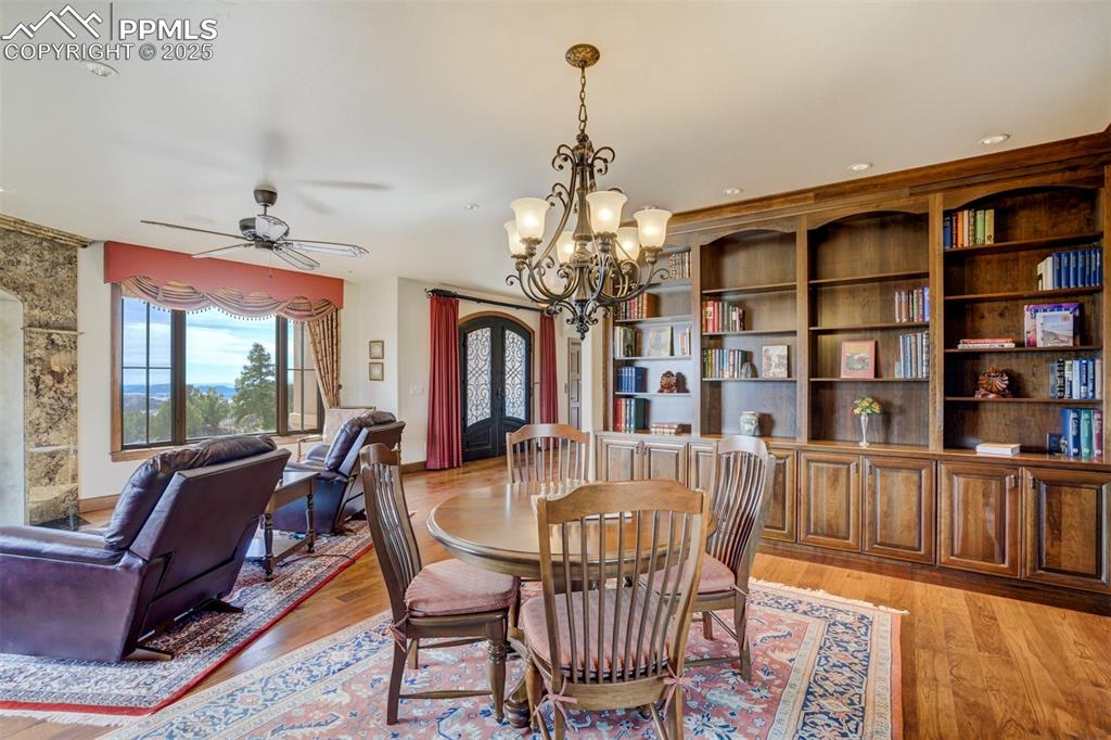 14250 Aiken Ride View Colorado Springs, CO 80926 - Photo 6 of 50 a view of a dining room with furniture window and wooden floor