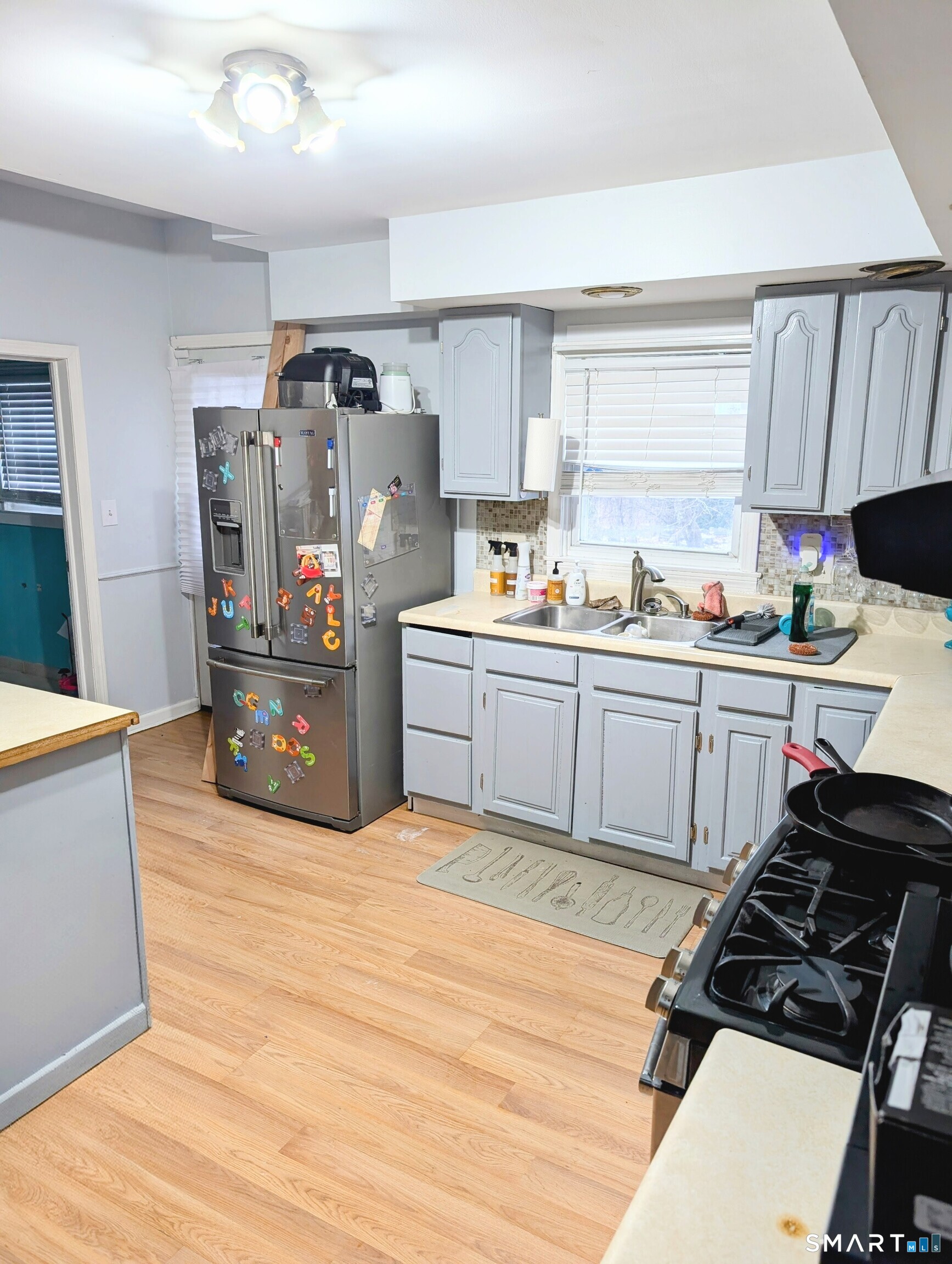 100 7th Street Norwich, CT 06360 - Photo 15 of 32 a kitchen with stainless steel appliances a sink and a stove