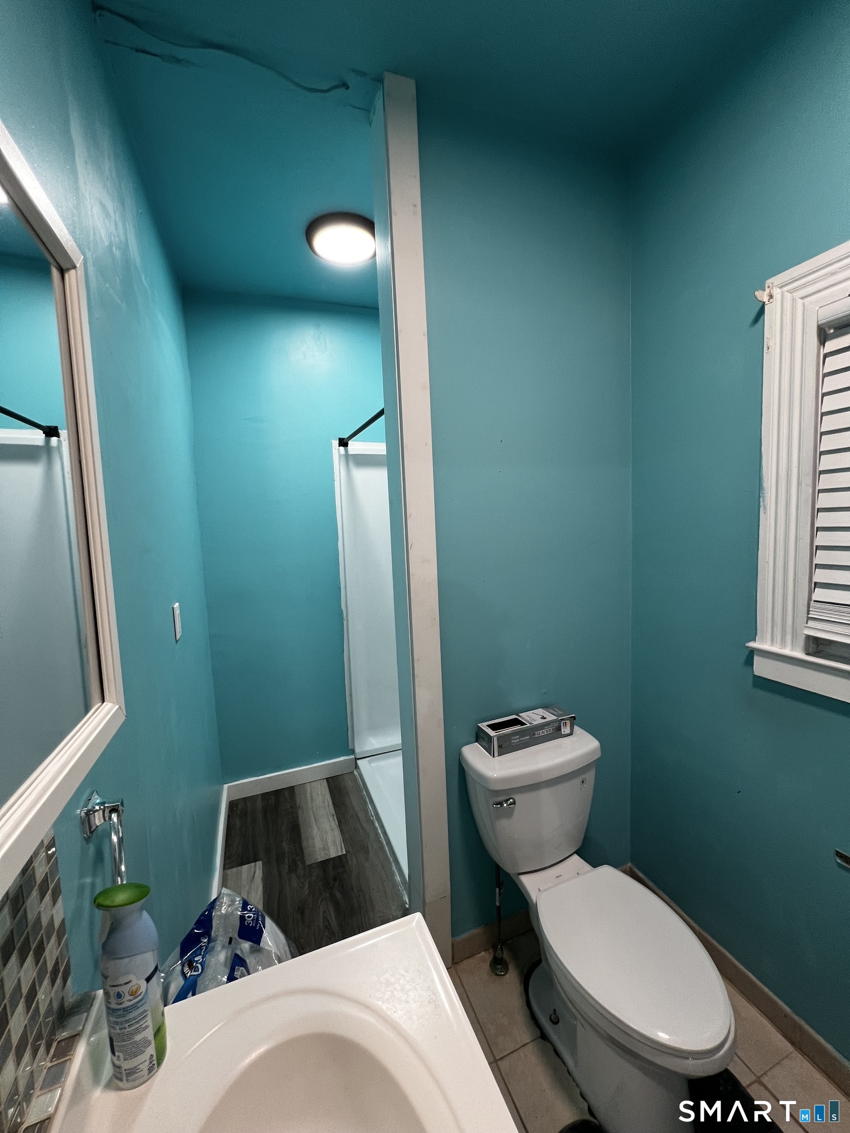 100 7th Street Norwich, CT 06360 - Photo 18 of 32 a bathroom with a toilet a sink and mirror