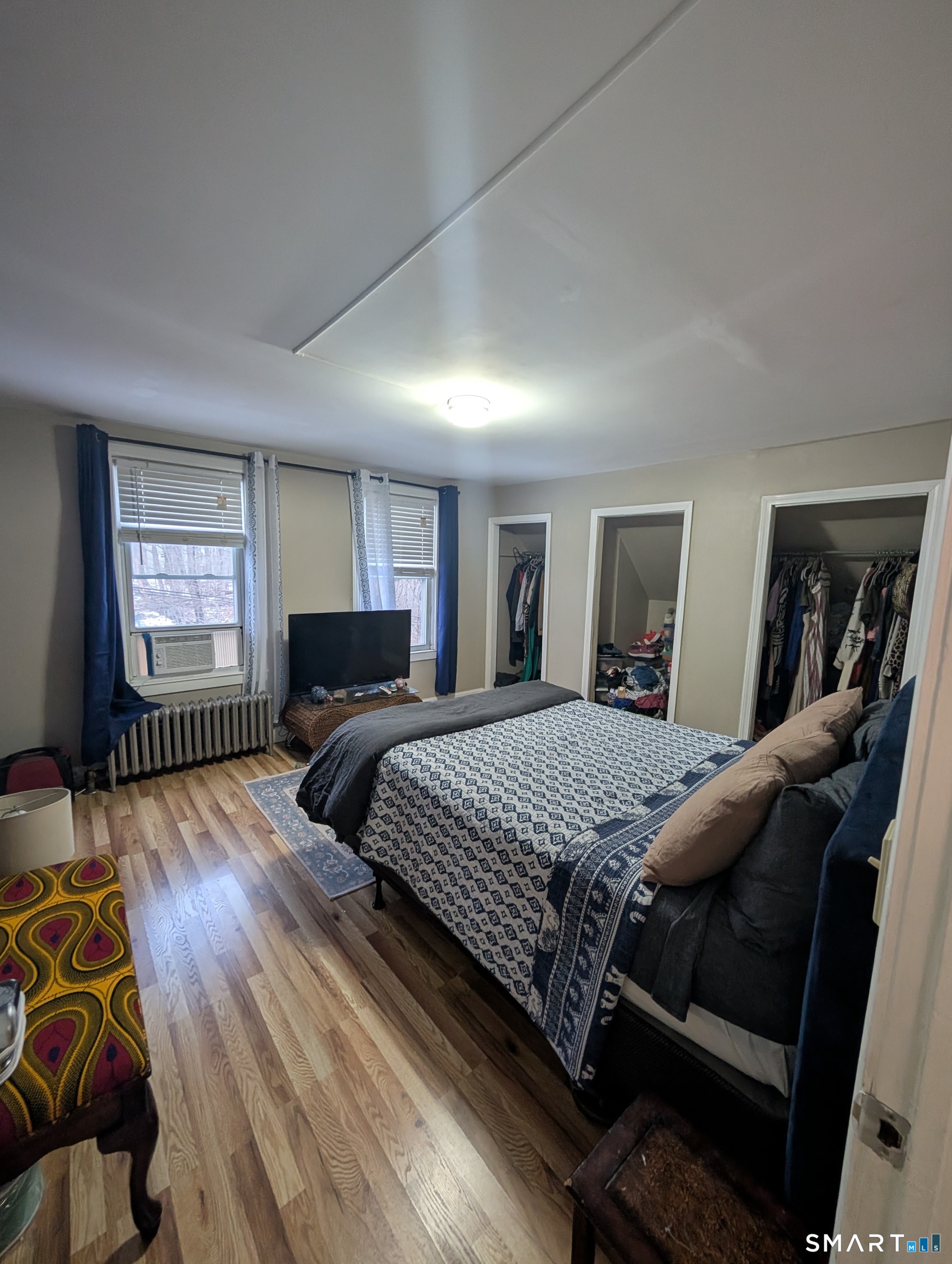 100 7th Street Norwich, CT 06360 - Photo 23 of 32 a bedroom with a bed and wooden floor