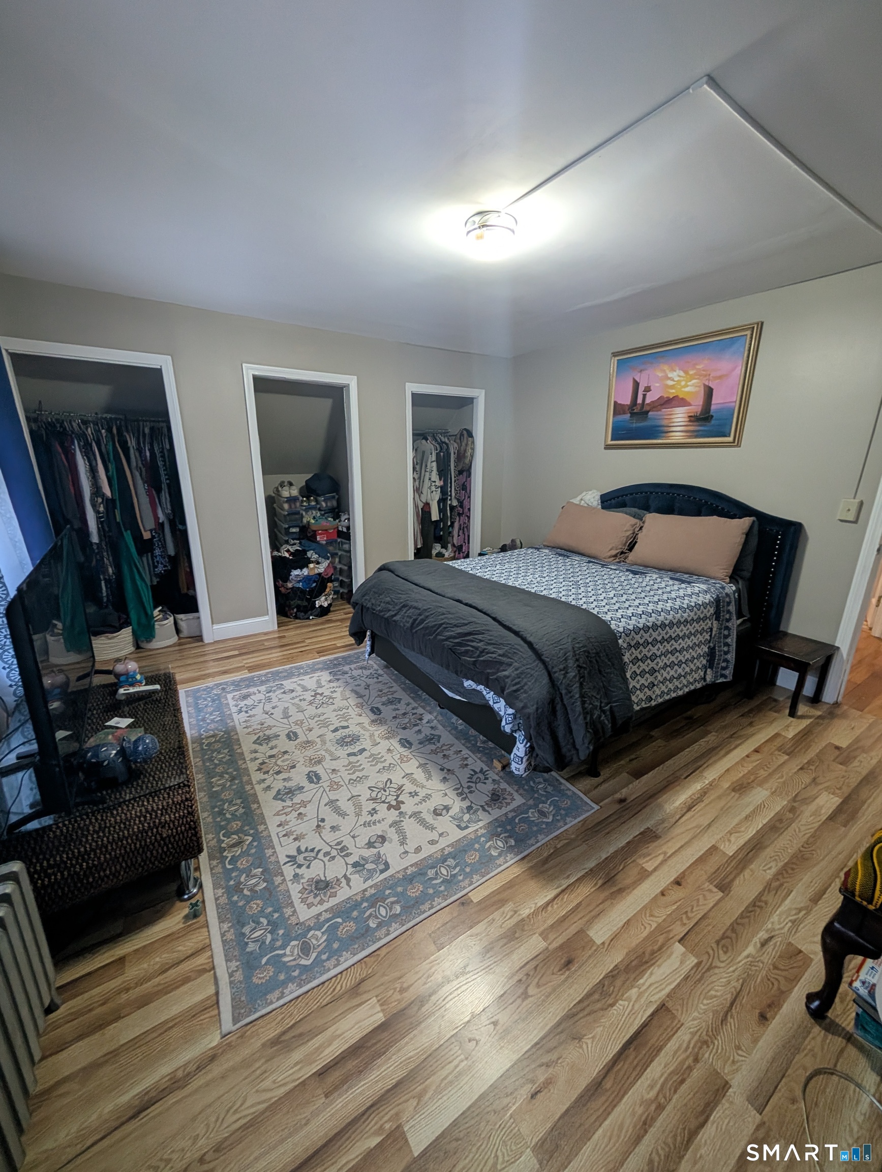 100 7th Street Norwich, CT 06360 - Photo 24 of 32 a bedroom with a bed a dresser and wooden floor