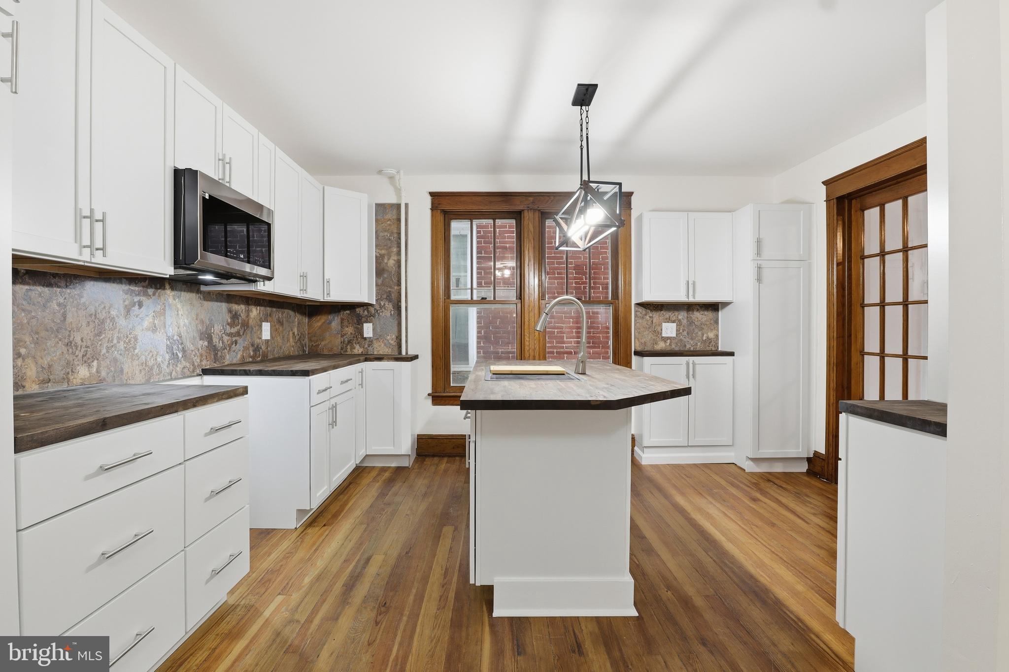 33 Sprenkle Avenue Hanover, PA 17331 - Photo 14 of 53 a kitchen with granite countertop a stove a sink and a microwave