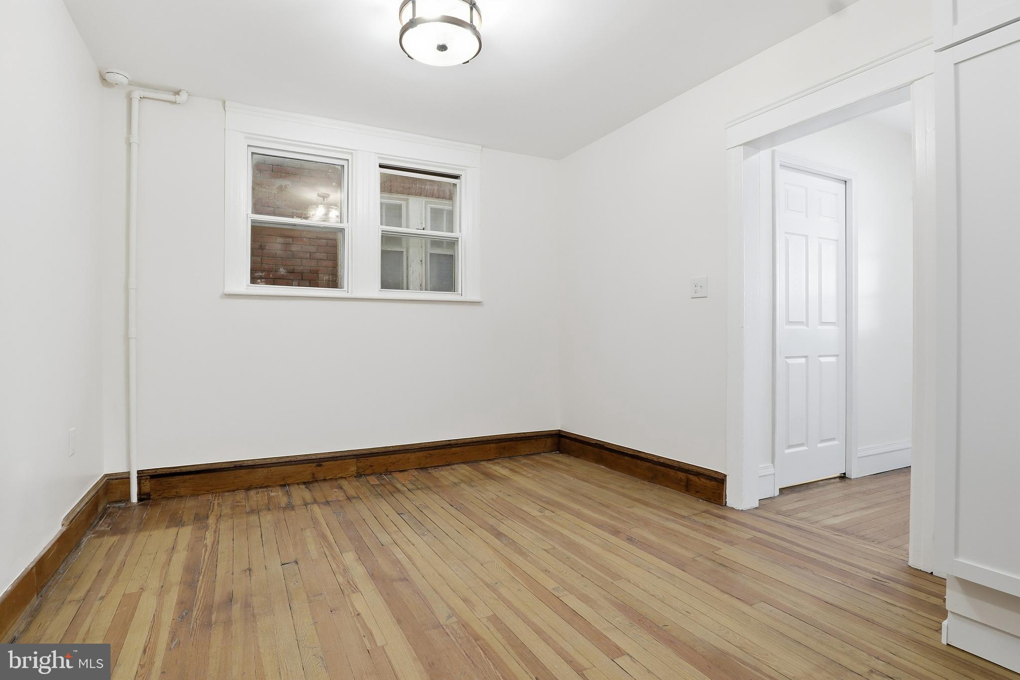 33 Sprenkle Avenue Hanover, PA 17331 - Photo 19 of 53 a view of an empty room with wooden floor and a window