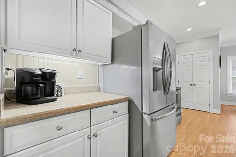 a kitchen with a refrigerator and cabinets