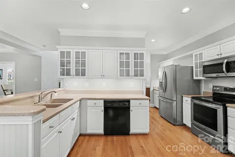 a kitchen with a sink stove and refrigerator