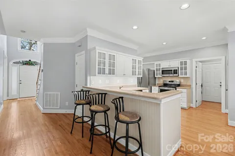 a kitchen that has a table and chairs in it