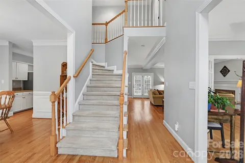 a view of entryway and hall with wooden floor