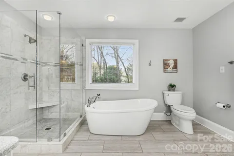 a spacious bathroom with a bathtub and shower