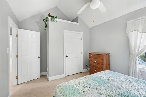 a bedroom with a bed and a dresser