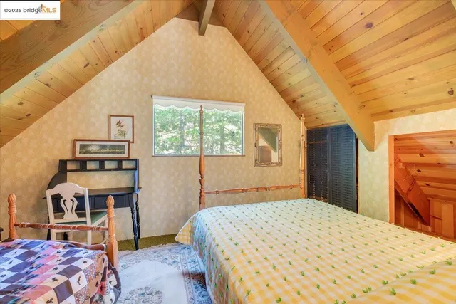 a large bed sitting in a bedroom next to a window