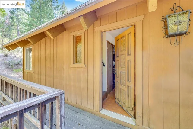a view of a patio with table and chairs and wooden floor