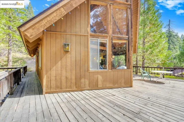 a balcony with wooden floor and outdoor seating