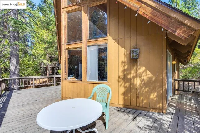 a view of balcony with wooden floor and fence