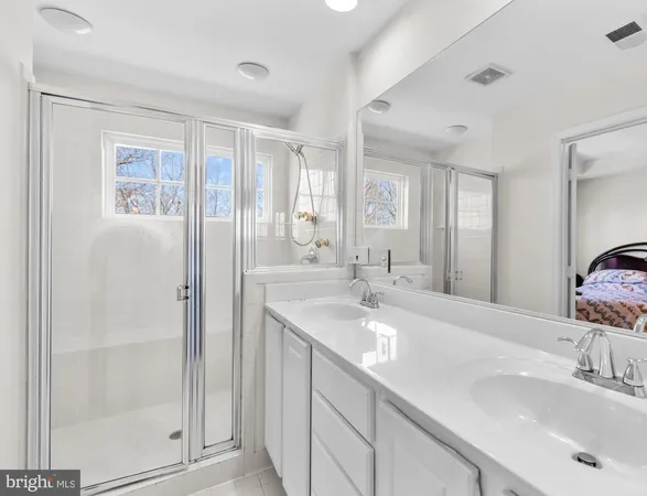 a bathroom with a shower sink and mirror