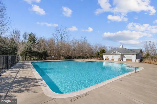 a view of a swimming pool and a yard