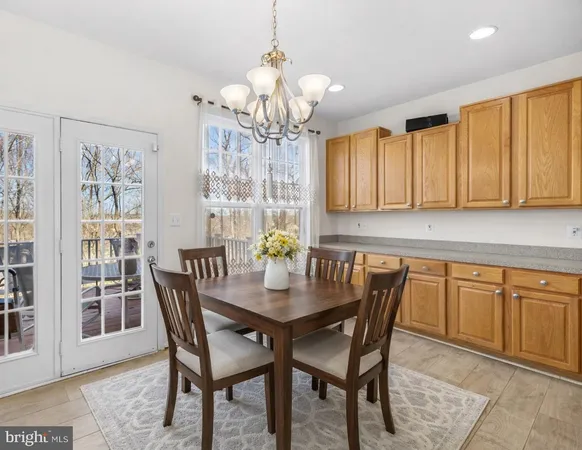 a view of a dining room with furniture and chandelier