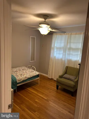 a living room with furniture and a lamp