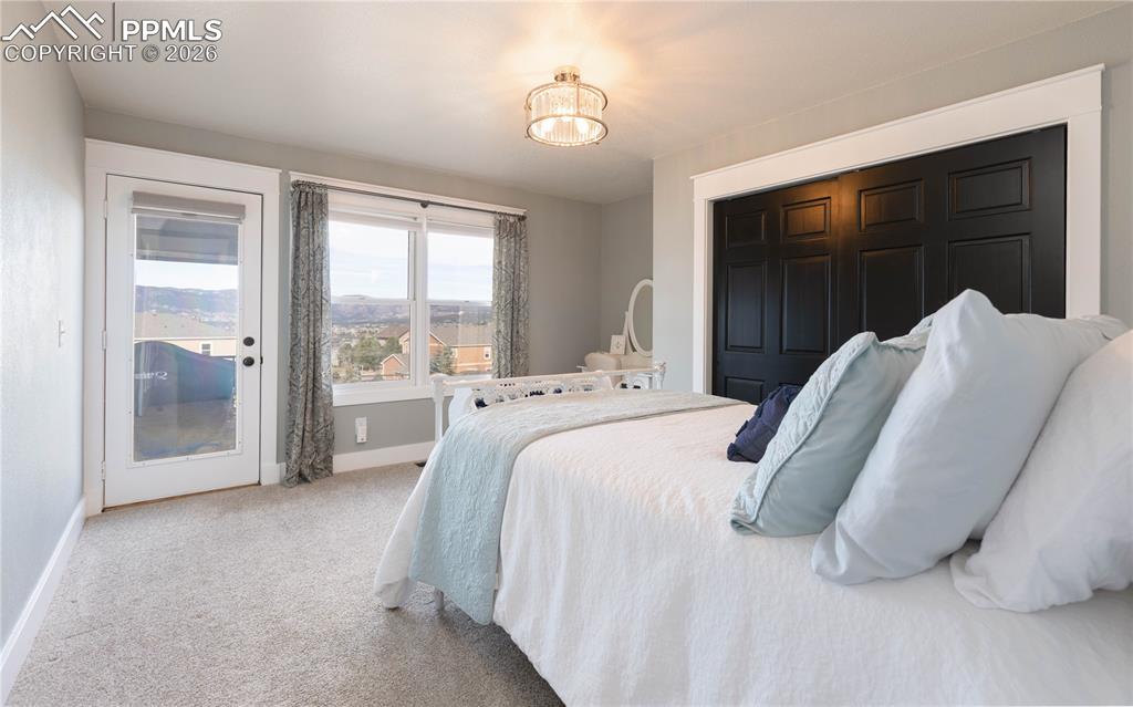 17840 New London Road Monument, CO 80132 - Photo 17 of 38 Main-level bedroom walks out to back deck with lovely view of the mountains