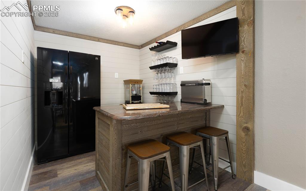 17840 New London Road Monument, CO 80132 - Photo 23 of 38 Basement bar area with full-size refrigerator