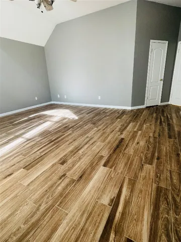 a spacious bathroom with a tub sink and mirror