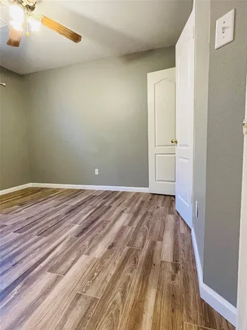 a view of a room with wooden floor