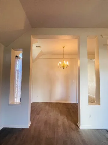 a view of hallway with wooden floor