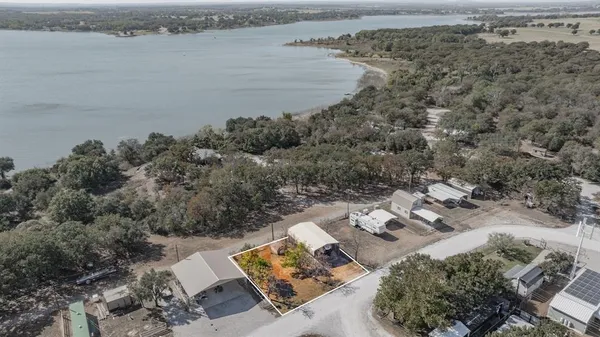 an aerial view of a house with a lake view