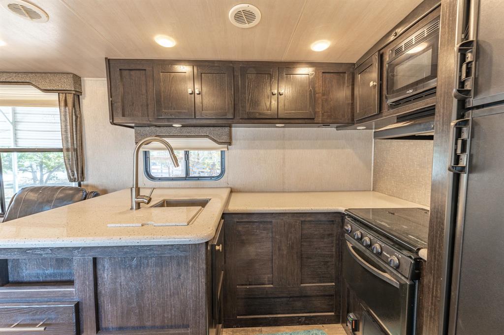 357 Discovery Bay Road Comanche, TX 76442 - Photo 14 of 32 a kitchen with a sink appliances and cabinets