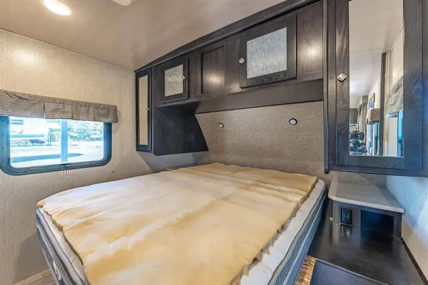 a bedroom with a bed and window